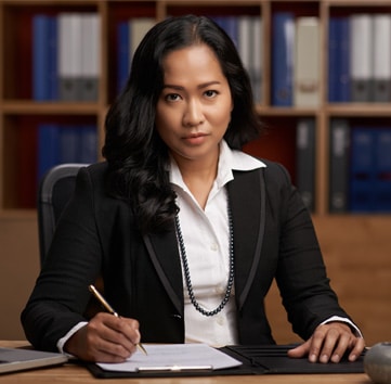 Lawyers-EO-Liability woman sitting at desk with pen